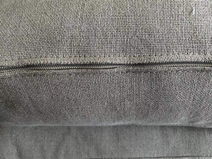 Close-up of zipper detail on Rene Sofa Lounge Chair's linen cushion.