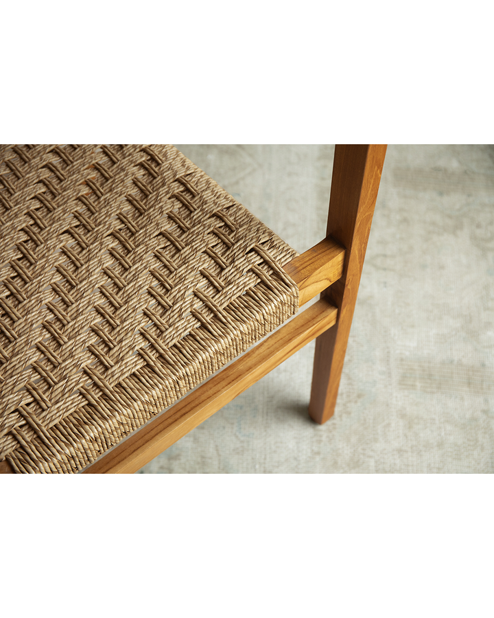 Reed Chair close-up featuring woven seat design and teak wood frame.