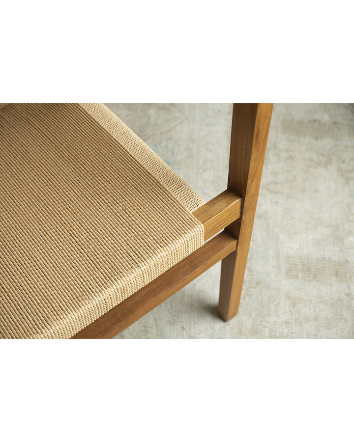 Close-up of Reed Chair showing natural woven seat detail and solid teak frame.