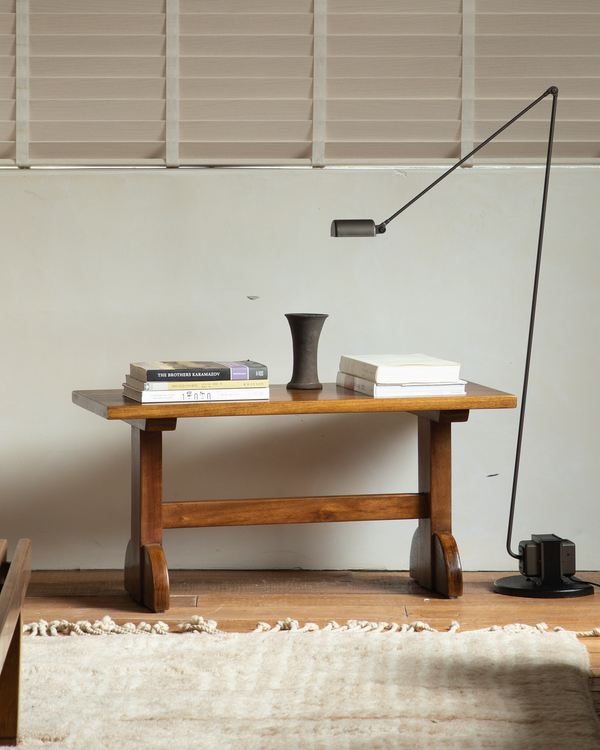 Hoof Side Table with lamp, books, and vase in a modern interior setting.