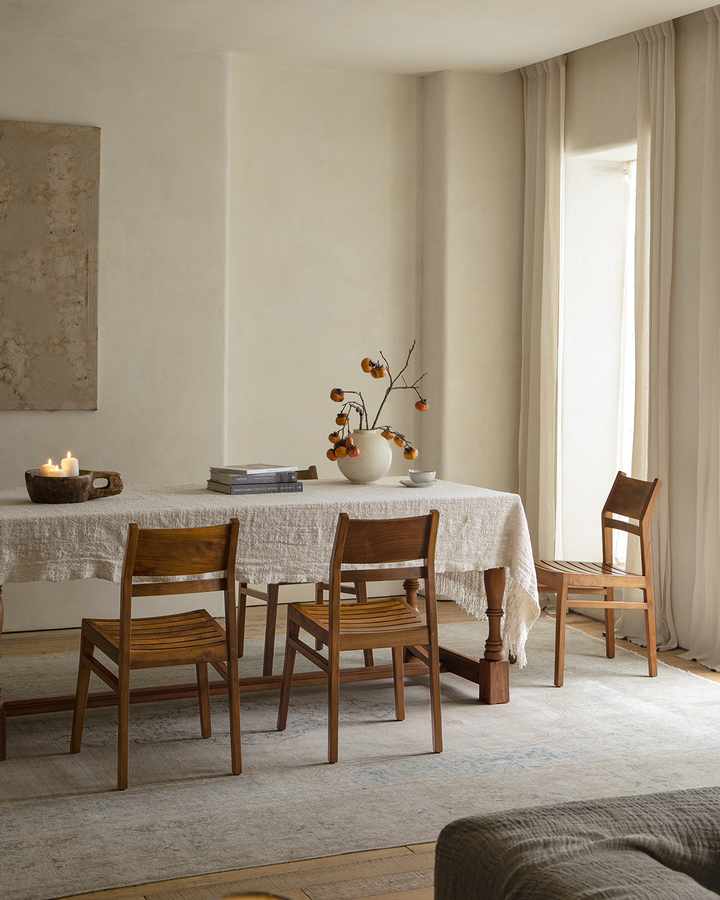 Beam Chair beside a rustic wooden table, featuring a cozy interior design.