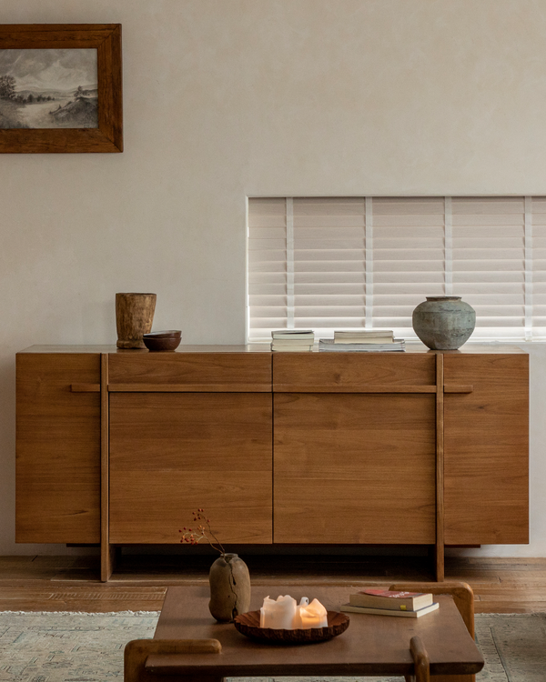 NO.42 sideboard in solid teak with decorative pottery and books on top