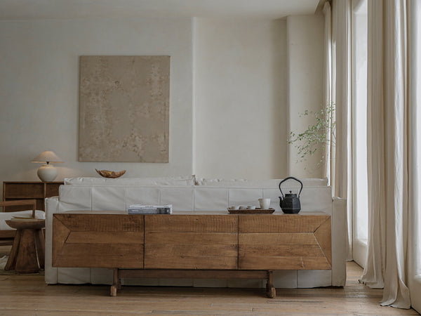 Modern vintage living room with wooden sideboard and white sofa