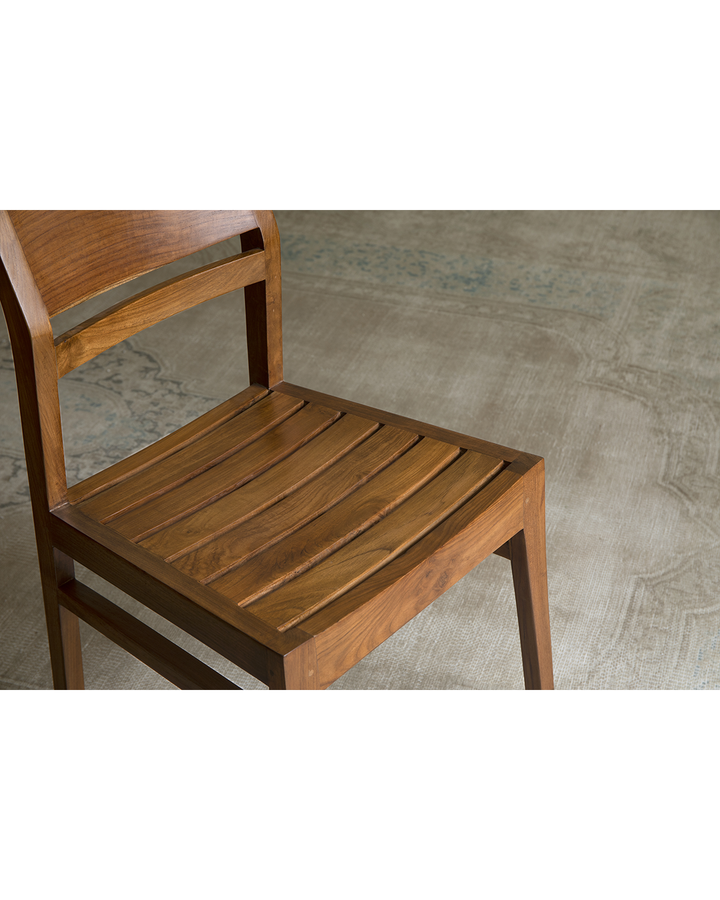 Close-up of Beam Chair's slatted teak wood seat highlighting natural craftsmanship.