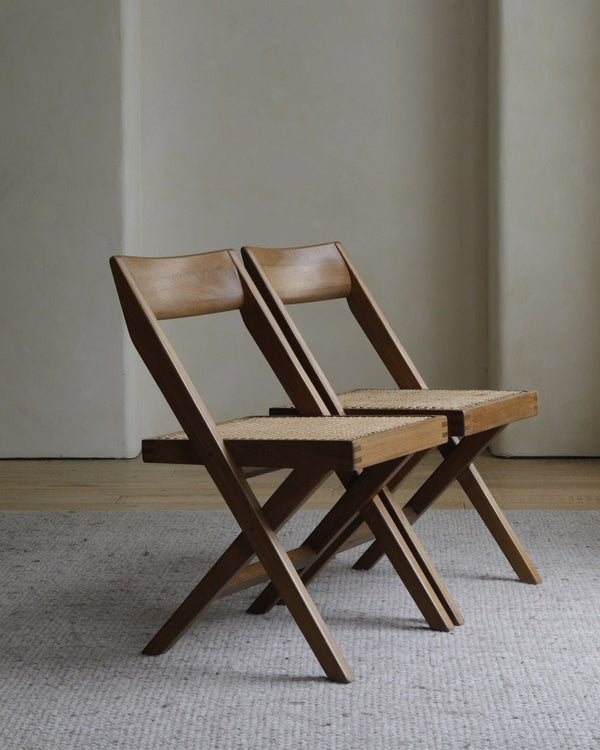 Pair of modern wooden folding chairs with rattan seats