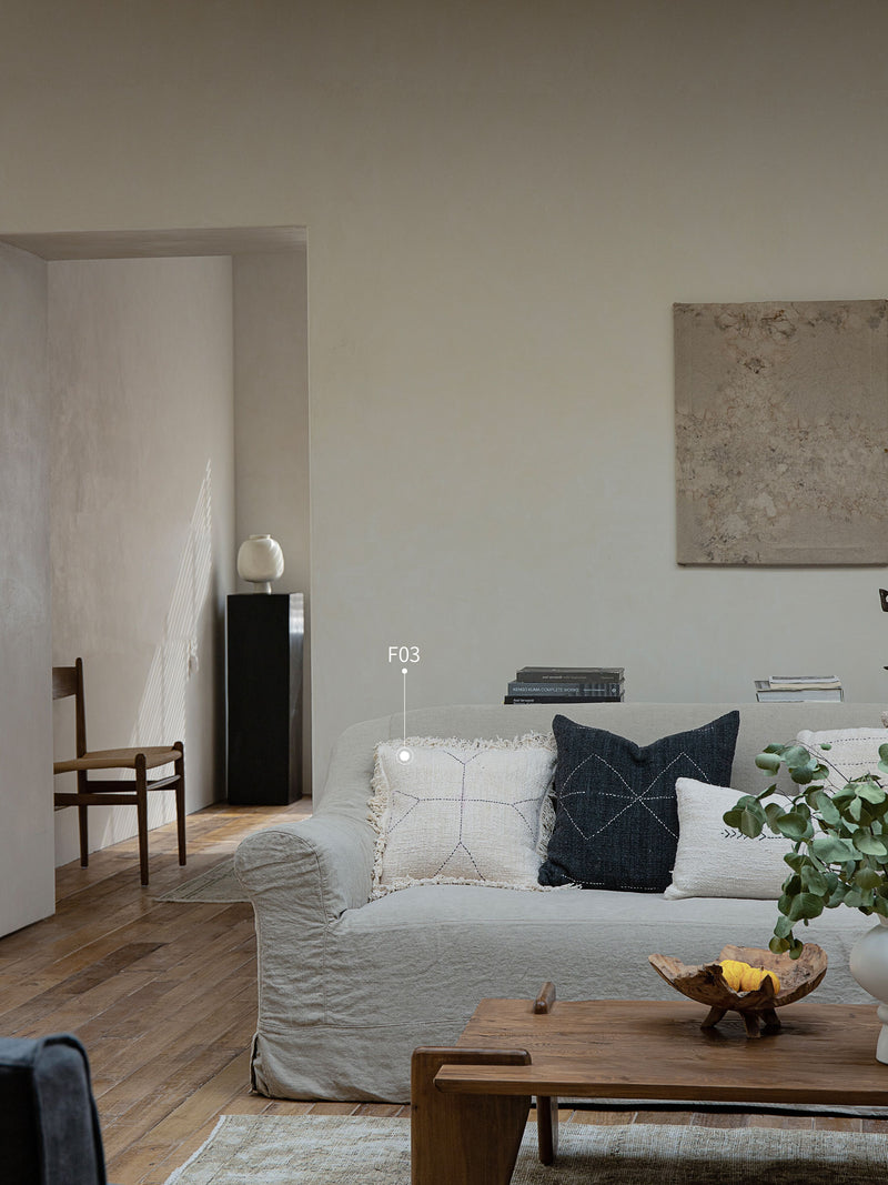 Beige sofa with decorative cotton pillows in a chic living room setting